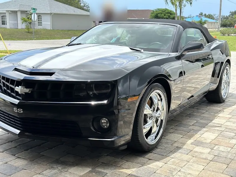 Black Camaro SS convertible with chrome wheels, freshly washed