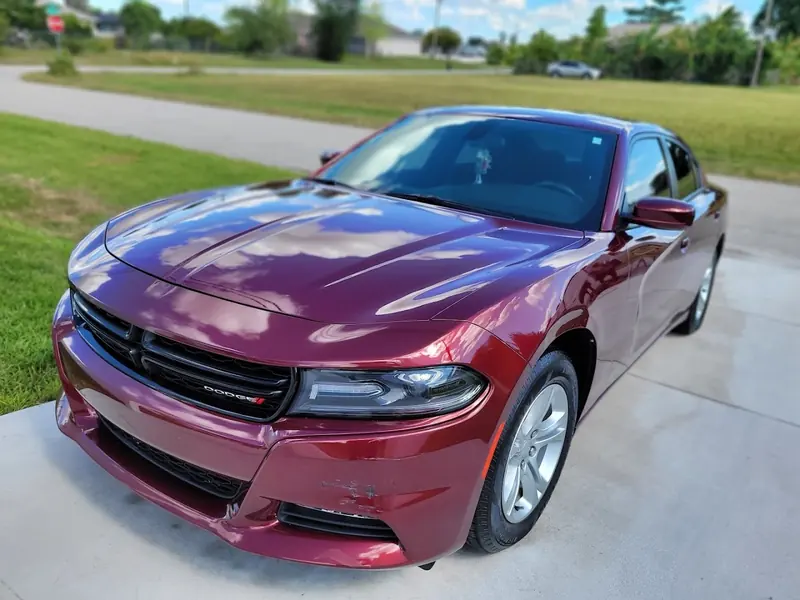 Burgundy Dodge Charger on a driveway