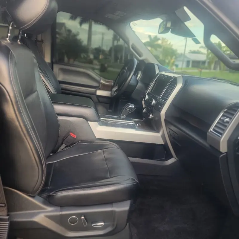Clean black leather seats and dashboard inside a Ford F-150