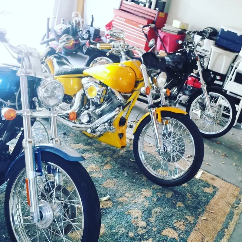Several motorcycles, one yellow, lined up