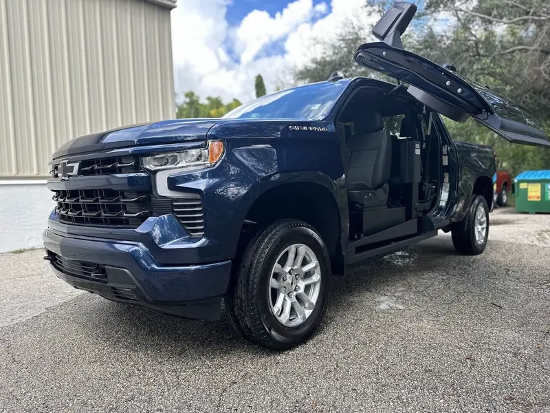 Dark blue Chevrolet Silverado with the door open